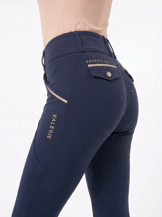 Navy riding breggings, back three-quarter view with gold logo print and VALERIE branding — Valerie Equestrian Tempo