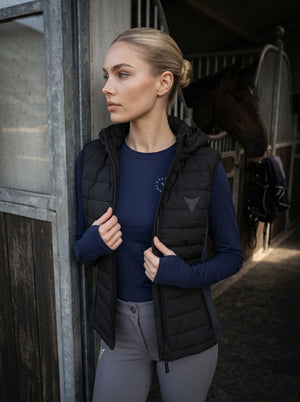 Black hooded riding gilet on model — Valerie Equestrian