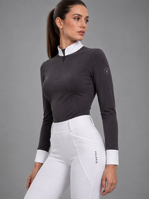 Grey long-sleeve show shirt worn with white competition leggings, three-quarter side view — Valerie Equestrian Distinction