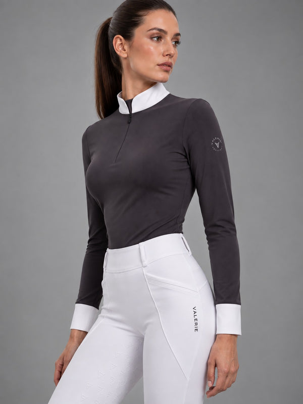 Grey long-sleeve show shirt worn with white competition leggings, three-quarter side view — Valerie Equestrian Distinction