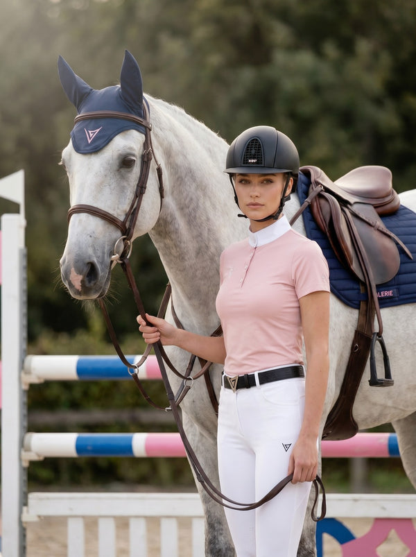 Navy saddle pad on grey horse, lifestyle — Valerie Equestrian