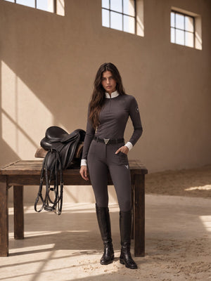 Rider in graphite grey full-seat riding breeches, three-quarter view — Valerie Equestrian Momentum